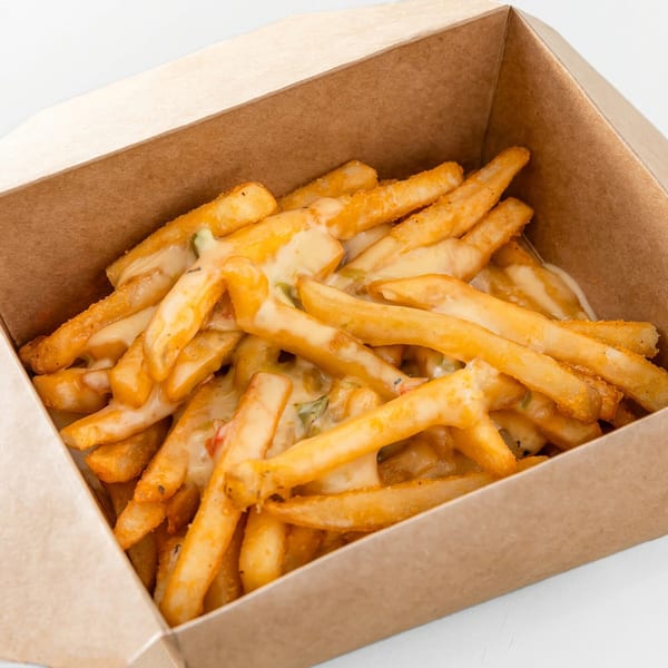 Cheesy fries from Burger Nerds, served in a brown cardboard container.
